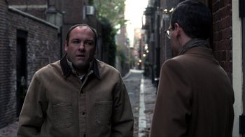 Movie still from “A Civil Action” (1998), directed by Steven Zaillian – Two men are standing on a sidewalk talking; Medium shot, Over the shoulder angle