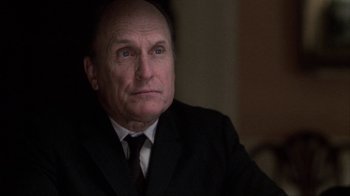 Movie still from “A Civil Action” (1998), directed by Steven Zaillian – An older man wearing a suit and tie looking at the camera; Close Up shot, Low angle