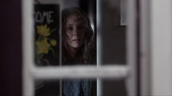 Movie still from “A Civil Action” (1998), directed by Steven Zaillian – A woman looking out of a window at home; Close Up shot, Over the shoulder angle