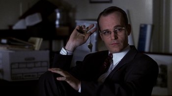 Movie still from “A Civil Action” (1998), directed by Steven Zaillian – A man in a suit and tie holding a key chain; Close Up shot, Low angle
