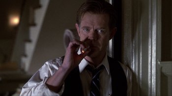 Movie still from “A Civil Action” (1998), directed by Steven Zaillian – A man smoking a cigarette while holding a cell phone to his ear; Close Up shot, Low angle