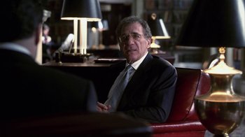 Movie still from “A Civil Action” (1998), directed by Steven Zaillian – A man in a suit and tie sitting in front of a computer; Medium shot, Over the shoulder angle