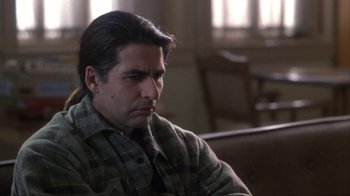 Movie still from “A Civil Action” (1998), directed by Steven Zaillian – A person sitting in a chair; Close Up shot, Over the shoulder angle