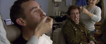 Movie still from “Tristram Shandy” (2005), directed by Michael Winterbottom – A man is brushing his teeth in a room; Close Up shot, Over the shoulder angle