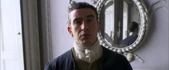 Movie still from “Tristram Shandy” (2005), directed by Michael Winterbottom – A man wearing a neck brace in front of a mirror; Close Up shot, Over the shoulder angle