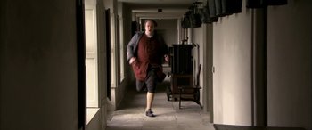 Movie still from “Tristram Shandy” (2005), directed by Michael Winterbottom – An old man running down the hall of an old house; Medium shot, High angle