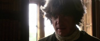 Movie still from “Tristram Shandy” (2005), directed by Michael Winterbottom – A person wearing a hat; Close Up shot, Over the shoulder angle