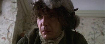 Movie still from “Tristram Shandy” (2005), directed by Michael Winterbottom – A person wearing a wig; Close Up shot, Over the shoulder angle