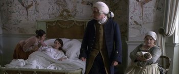 Movie still from “Tristram Shandy” (2005), directed by Michael Winterbottom – A man and a woman in a bed room; Medium shot, High angle