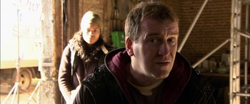 Movie still from “Tristram Shandy” (2005), directed by Michael Winterbottom – A man and a woman are looking at the camera; Close Up shot, Over the shoulder angle