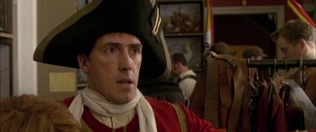 Movie still from “Tristram Shandy” (2005), directed by Michael Winterbottom – A person wearing a hat; Close Up shot, Over the shoulder angle