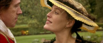 Movie still from “Tristram Shandy” (2005), directed by Michael Winterbottom – A person wearing a hat and looking up; Close Up shot, Over the shoulder angle