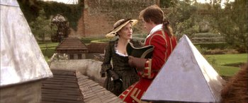 Movie still from “Tristram Shandy” (2005), directed by Michael Winterbottom – A man and a woman dressed in period clothing; Medium shot, High angle
