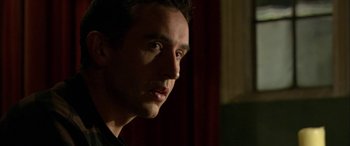 Movie still from “Tristram Shandy” (2005), directed by Michael Winterbottom – A man's face in the dark; Close Up shot, Low angle