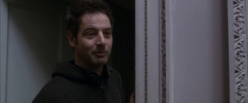 Movie still from “Tristram Shandy” (2005), directed by Michael Winterbottom – A person standing in front of a door; Close Up shot, Over the shoulder angle