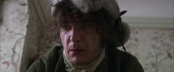 Movie still from “Tristram Shandy” (2005), directed by Michael Winterbottom – A person wearing a hat; Close Up shot, Over the shoulder angle