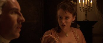 Movie still from “Tristram Shandy” (2005), directed by Michael Winterbottom – A young woman wearing a dress and a necklace; Close Up shot, Over the shoulder angle