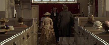 Movie still from “Tristram Shandy” (2005), directed by Michael Winterbottom – Two men and a woman dressed in period clothing; Wide shot, High angle
