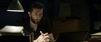 Movie still from “Department Q: A Conspiracy of Faith” (2016), directed by Hans Petter Moland – A man sitting in front of a laptop computer; Close Up shot, Low angle