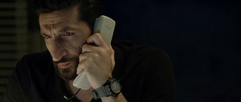 Movie still from “Department Q: A Conspiracy of Faith” (2016), directed by Hans Petter Moland – A man holding a cell phone up to his ear; Close Up shot, High angle
