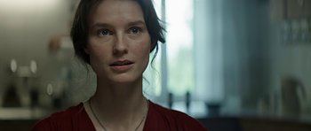Movie still from “Department Q: A Conspiracy of Faith” (2016), directed by Hans Petter Moland – A person wearing a red shirt; Close Up shot, Over the shoulder angle