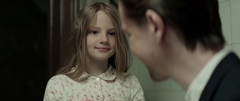 Movie still from “Department Q: A Conspiracy of Faith” (2016), directed by Hans Petter Moland – A young girl looking at a man in the mirror; Close Up shot, Over the shoulder angle