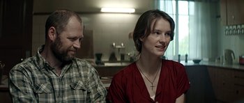 Movie still from “Department Q: A Conspiracy of Faith” (2016), directed by Hans Petter Moland – A man and a woman sitting next to each other in a room; Close Up shot, Over the shoulder angle