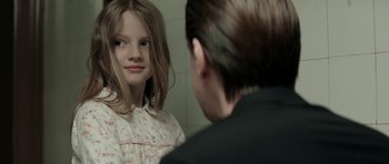 Movie still from “Department Q: A Conspiracy of Faith” (2016), directed by Hans Petter Moland – A young girl looking at a man in the mirror; Close Up shot, Over the shoulder angle