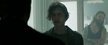 Movie still from “Department Q: A Conspiracy of Faith” (2016), directed by Hans Petter Moland – A young man is looking at the camera; Close Up shot, Over the shoulder angle