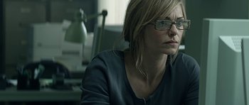 Movie still from “Department Q: A Conspiracy of Faith” (2016), directed by Hans Petter Moland – A woman sitting in front of a desk with a lamp; Close Up shot, Over the shoulder angle