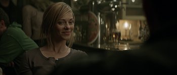 Movie still from “Department Q: A Conspiracy of Faith” (2016), directed by Hans Petter Moland – A woman sitting at a bar looking into a mirror; Close Up shot, Over the shoulder angle