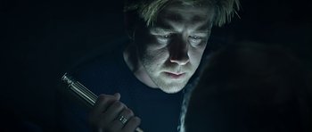 Movie still from “Department Q: A Conspiracy of Faith” (2016), directed by Hans Petter Moland – A person looking at a cell phone; Close Up shot, Over the shoulder angle