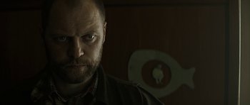 Movie still from “Department Q: A Conspiracy of Faith” (2016), directed by Hans Petter Moland – A person wearing a jacket; Close Up shot, Over the shoulder angle