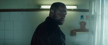 Movie still from “Department Q: A Conspiracy of Faith” (2016), directed by Hans Petter Moland – A person with a beard in a room; Close Up shot, Low angle