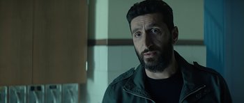 Movie still from “Department Q: A Conspiracy of Faith” (2016), directed by Hans Petter Moland – A man with a beard is looking at the camera; Close Up shot, Over the shoulder angle