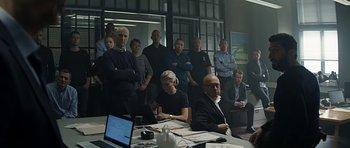 Movie still from “Department Q: A Conspiracy of Faith” (2016), directed by Hans Petter Moland – A group of people sitting at a table in front of a computer; Wide shot, Low angle