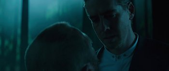 Movie still from “Department Q: A Conspiracy of Faith” (2016), directed by Hans Petter Moland – A man in a white shirt is talking to another man; Close Up shot, Over the shoulder angle