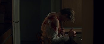Movie still from “Department Q: A Conspiracy of Faith” (2016), directed by Hans Petter Moland – A young man with blood all over his shirt; Medium shot, Over the shoulder angle