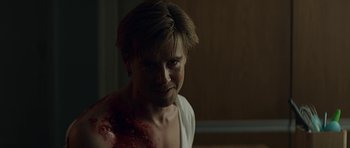 Movie still from “Department Q: A Conspiracy of Faith” (2016), directed by Hans Petter Moland – A young man with a bloody shirt on his chest; Close Up shot, Over the shoulder angle