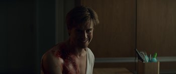 Movie still from “Department Q: A Conspiracy of Faith” (2016), directed by Hans Petter Moland – A young man with blood all over his face; Medium shot, Over the shoulder angle