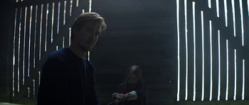 Movie still from “Department Q: A Conspiracy of Faith” (2016), directed by Hans Petter Moland – A man and a woman in a dark room; Medium shot, Over the shoulder angle