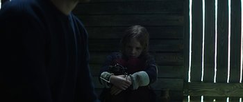 Movie still from “Department Q: A Conspiracy of Faith” (2016), directed by Hans Petter Moland – A little girl is holding onto a chain; Medium shot, Over the shoulder angle