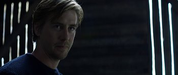 Movie still from “Department Q: A Conspiracy of Faith” (2016), directed by Hans Petter Moland – A person wearing a blue t - shirt; Close Up shot, Over the shoulder angle