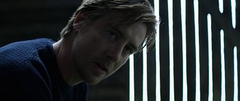 Movie still from “Department Q: A Conspiracy of Faith” (2016), directed by Hans Petter Moland – A man's face in front of a window; Close Up shot, Low angle