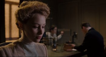 Movie still from “A Dangerous Method” (2011), directed by David Cronenberg – A woman in a white dress sitting in front of a mirror; Close Up shot, Over the shoulder angle