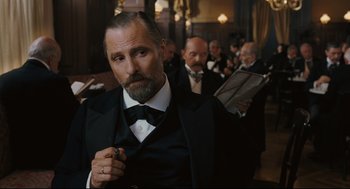 Movie still from “A Dangerous Method” (2011), directed by David Cronenberg – A man with a beard in a black suit and bow tie; Close Up shot, Low angle