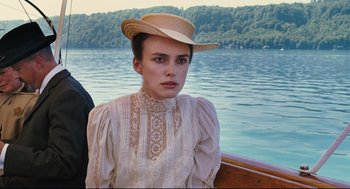Movie still from “A Dangerous Method” (2011), directed by David Cronenberg – A woman in a hat and a white dress on a boat in a body of water; Close Up shot, High angle
