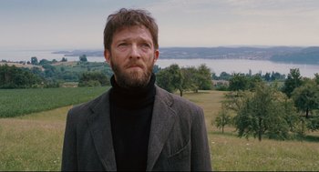 Movie still from “A Dangerous Method” (2011), directed by David Cronenberg – A man with a beard wearing a jacket and a sweater; Medium shot, Low angle