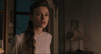 Movie still from “A Dangerous Method” (2011), directed by David Cronenberg – A woman in a white shirt standing in front of a window; Close Up shot, Over the shoulder angle