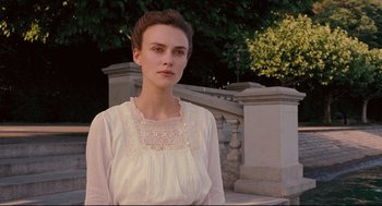 Movie still from “A Dangerous Method” (2011), directed by David Cronenberg – A woman in a white dress standing in front of a stone wall; Close Up shot, Over the shoulder angle
